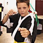 Focused student executing punch technique with confidence at Championship Martial Arts