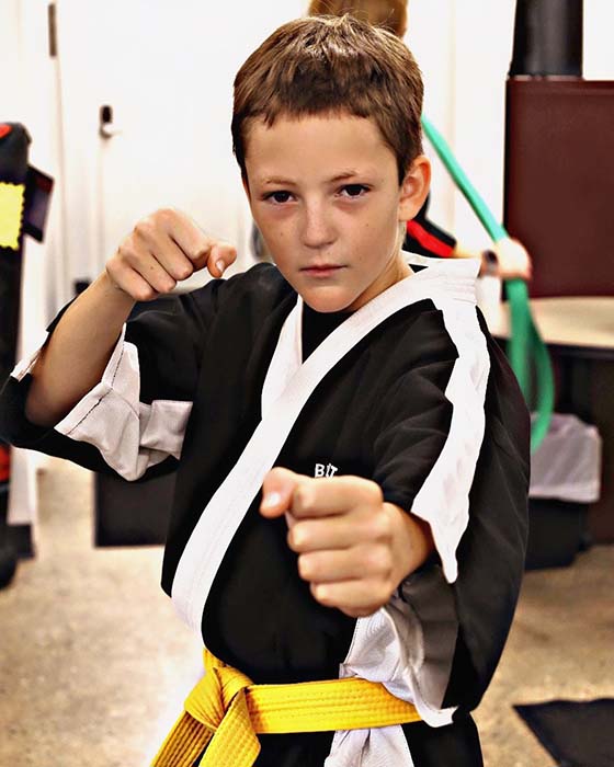 Focused student executing punch technique with confidence at Championship Martial Arts